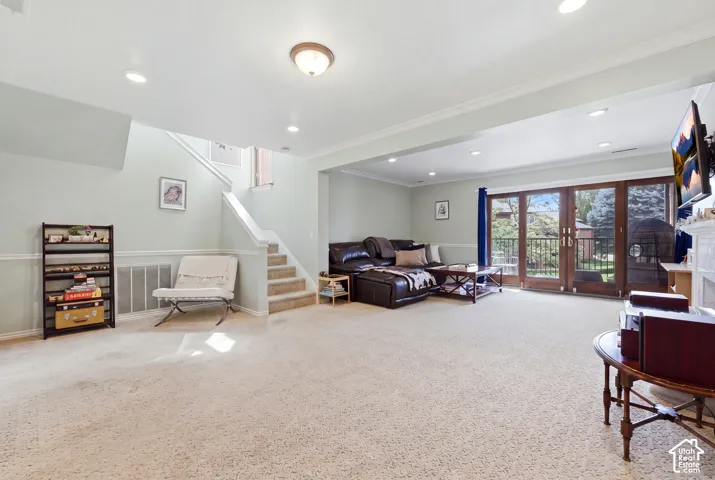 Recessed lighting, crown molding, double French patio doors, and carpeted flooring