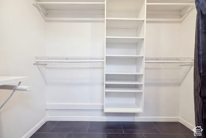 Custom closet organization system featuring multiple shelves and hanging rods