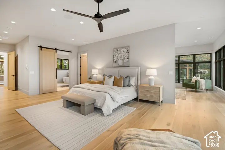 Spacious room featuring wood-finish flooring, recessed lighting, and a modern ceiling fan