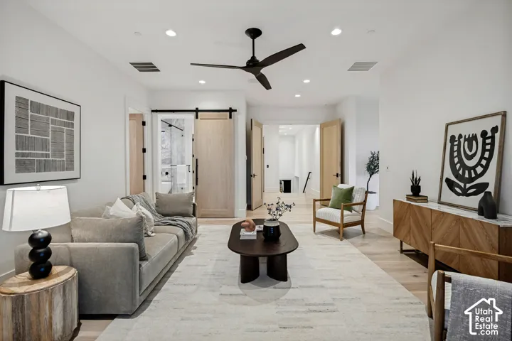 Recessed lighting, wood-finish flooring, and a ceiling fan