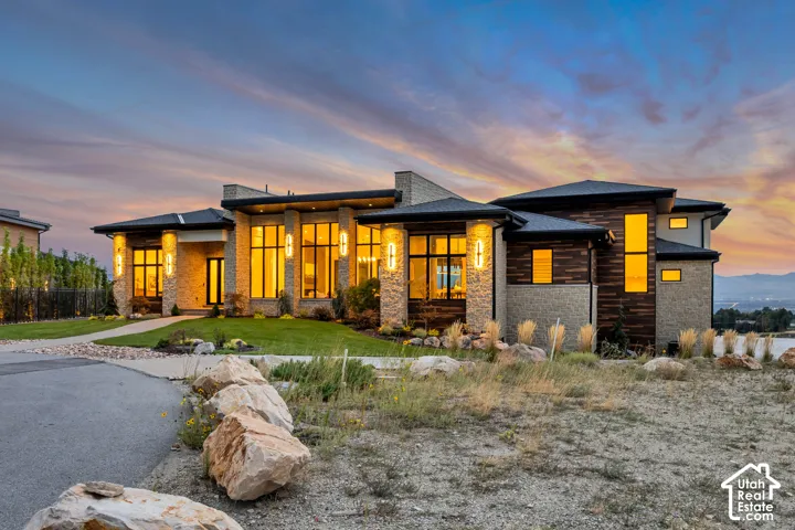 Modern architectural design featuring stone and wood-finish siding