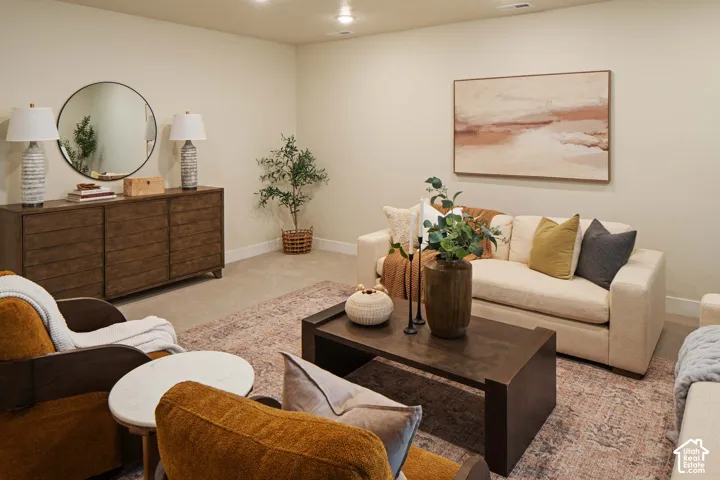 Recessed ceiling lighting illuminates the light-toned walls and carpeted flooring