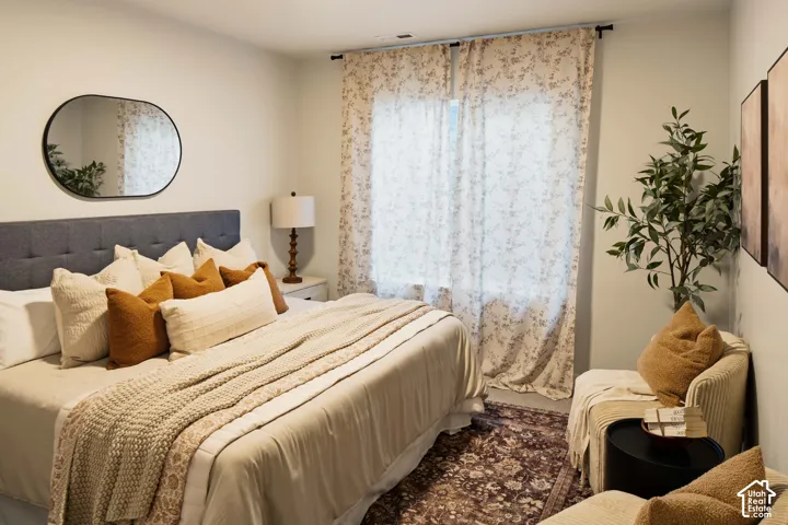 Built-in ceiling light fixture, textile wall hangings, and a fabric-upholstered headboard
