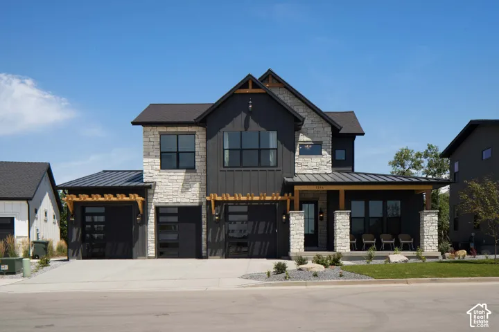 Modern exterior featuring a combination of stone and vertical siding