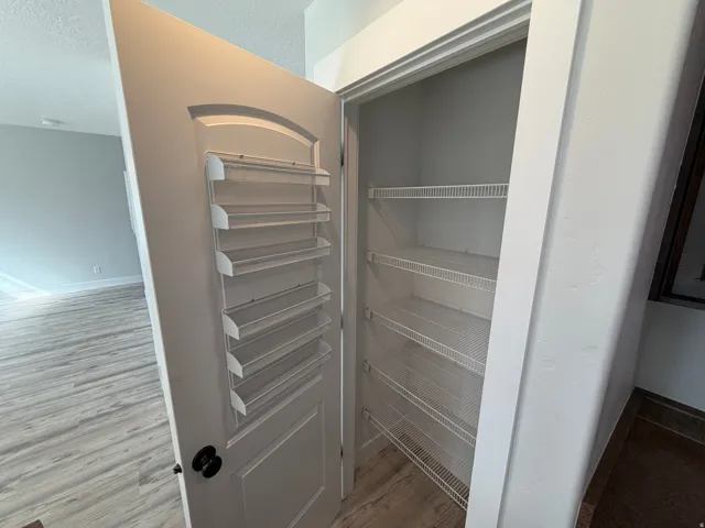 Built-in wire shelving within a door-mounted storage unit