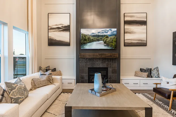 Floor-to-ceiling fireplace featuring a tile surround and wood mantel