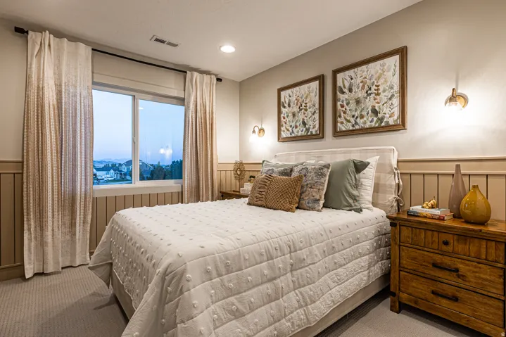 Recessed ceiling lighting, wall-mounted sconces, and a window provide illumination