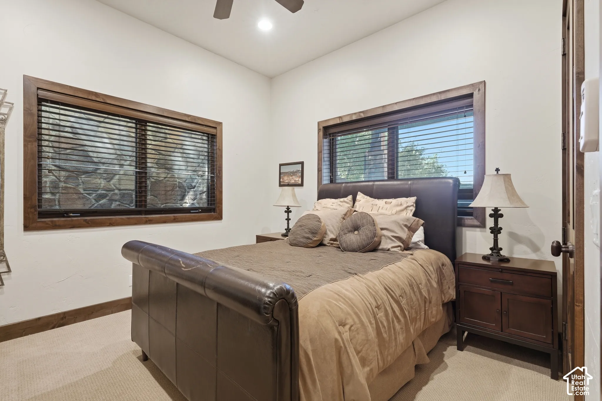 Recessed lighting, ceiling fan, wood-trimmed windows with blinds, and white wall finishes