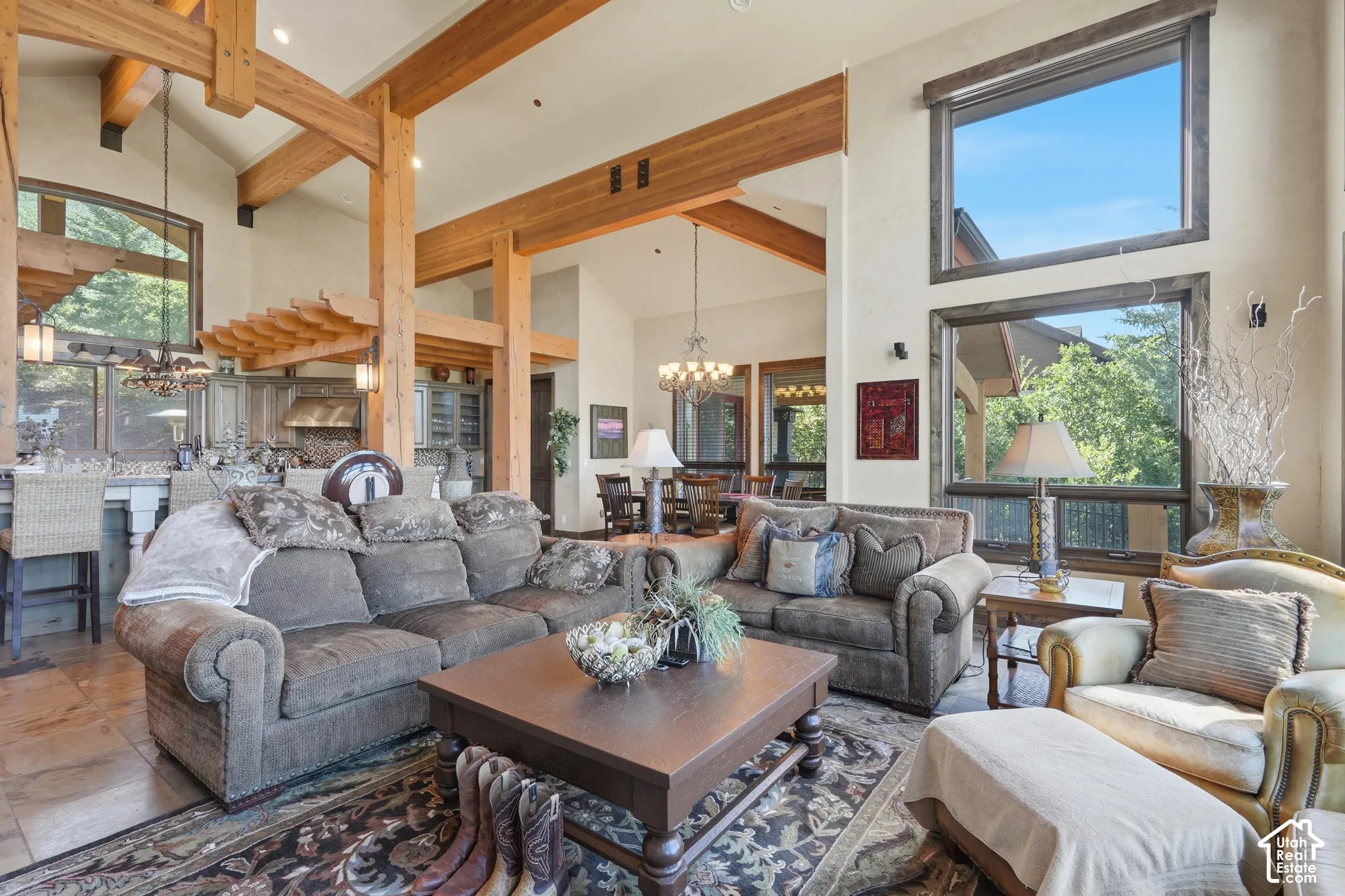 Exposed wood beams, vaulted ceilings, and large windows with wood trim