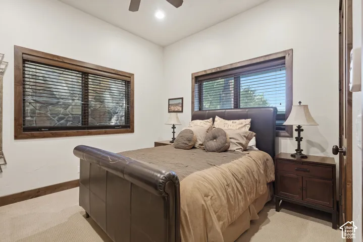 Recessed lighting, ceiling fan, wood-trimmed windows with blinds, and white wall finishes