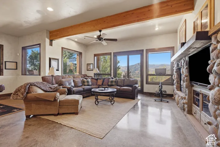 Exposed wood beam, recessed lighting, and ceiling fan