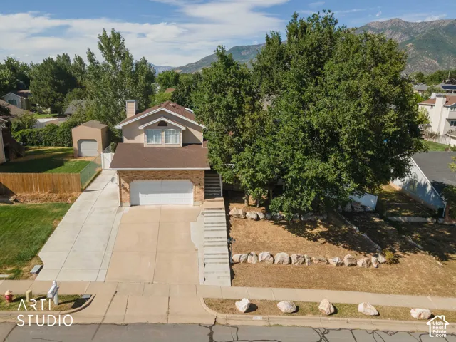 Brick veneer and stucco exterior with an attached garage