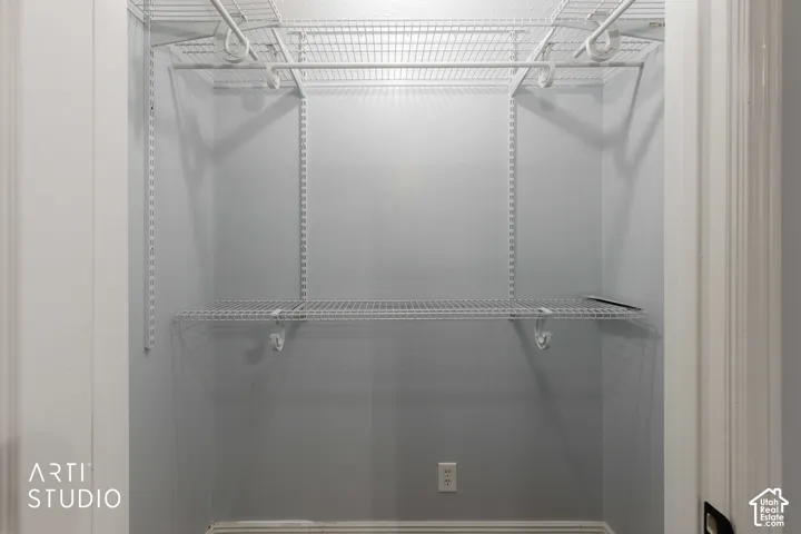 Closet in mother-in-law suite. Built-in wire shelving and hanging rods