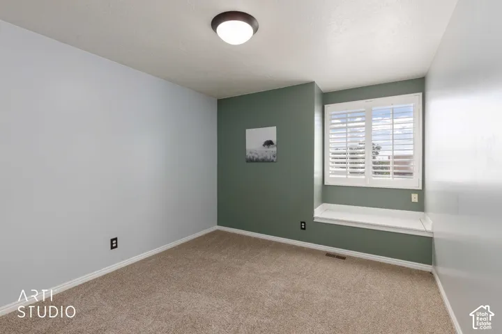 Carpeted flooring, recessed window, plantation shutters, built-in window seat, and flush mount ceiling fixture