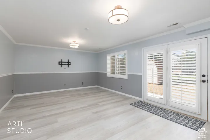 Wood-finish flooring with dual-toned walls and crown molding