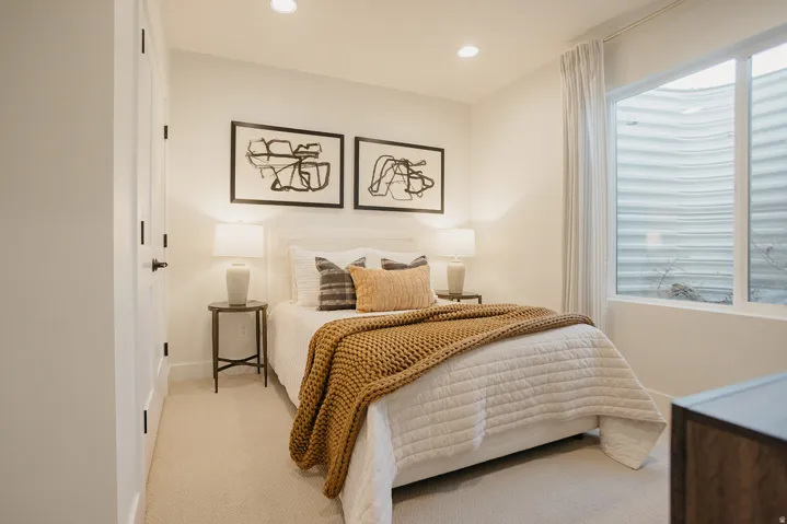 Recessed lighting, wall-to-wall carpeting, and a window with a window well