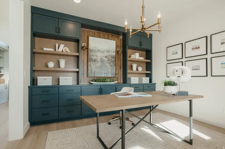 Built-in cabinetry with a wood-finish accent wall, gold-toned chandelier, and wood-finish flooring