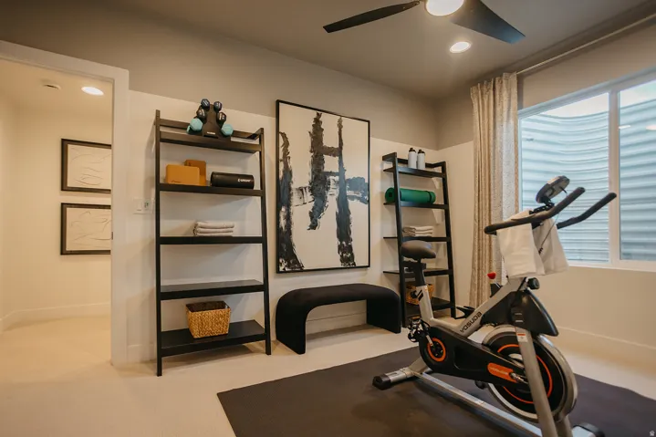 Recessed lighting, ceiling fan, window with window well, light-toned carpeting, and built-in shelving