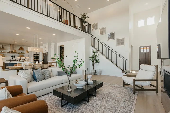 Open-concept living area with soaring ceilings and wood-finish flooring
