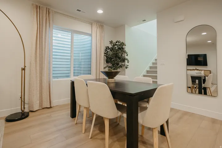 Recessed lighting, wood-finish flooring, a contemporary staircase with carpeted treads, and a window with blinds