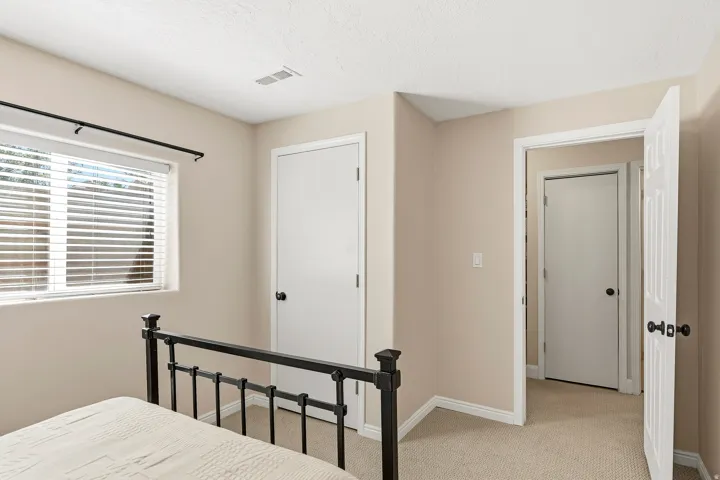 Window with horizontal blinds, neutral wall paint, white trim, and carpeted flooring