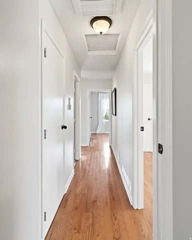 Wood-finish flooring in a white-painted hallway
