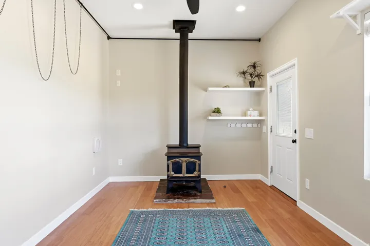 Hardwood-finish flooring, recessed lighting, and a wood-burning stove