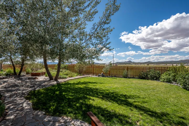 Expansive lawn bordered by a wood privacy fence