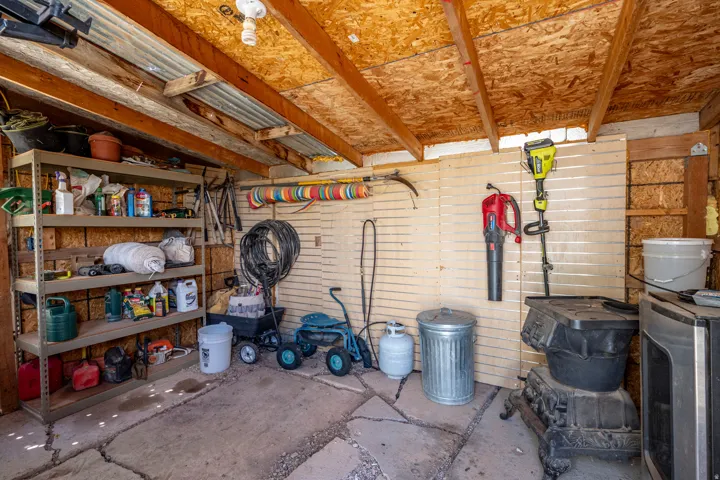 Utility shed with exposed wood beams and corrugated metal roofing
