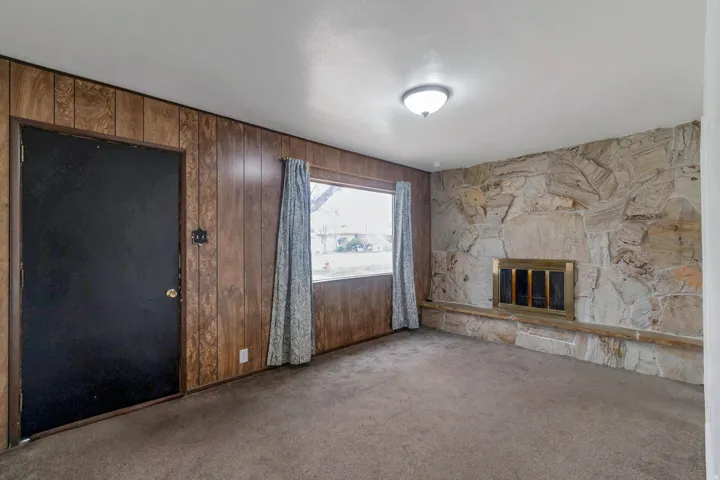 Stone accent wall with a built-in fireplace and hearth
