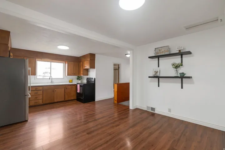 Open concept living area with wood-finish flooring