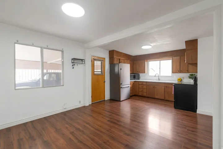 Wood-finish flooring throughout, white walls, and a recessed circular light fixture