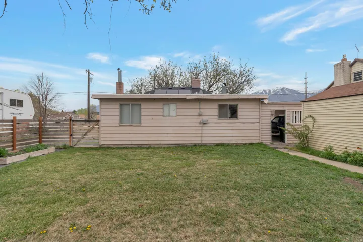 Expansive grassy yard with a horizontal slat privacy fence