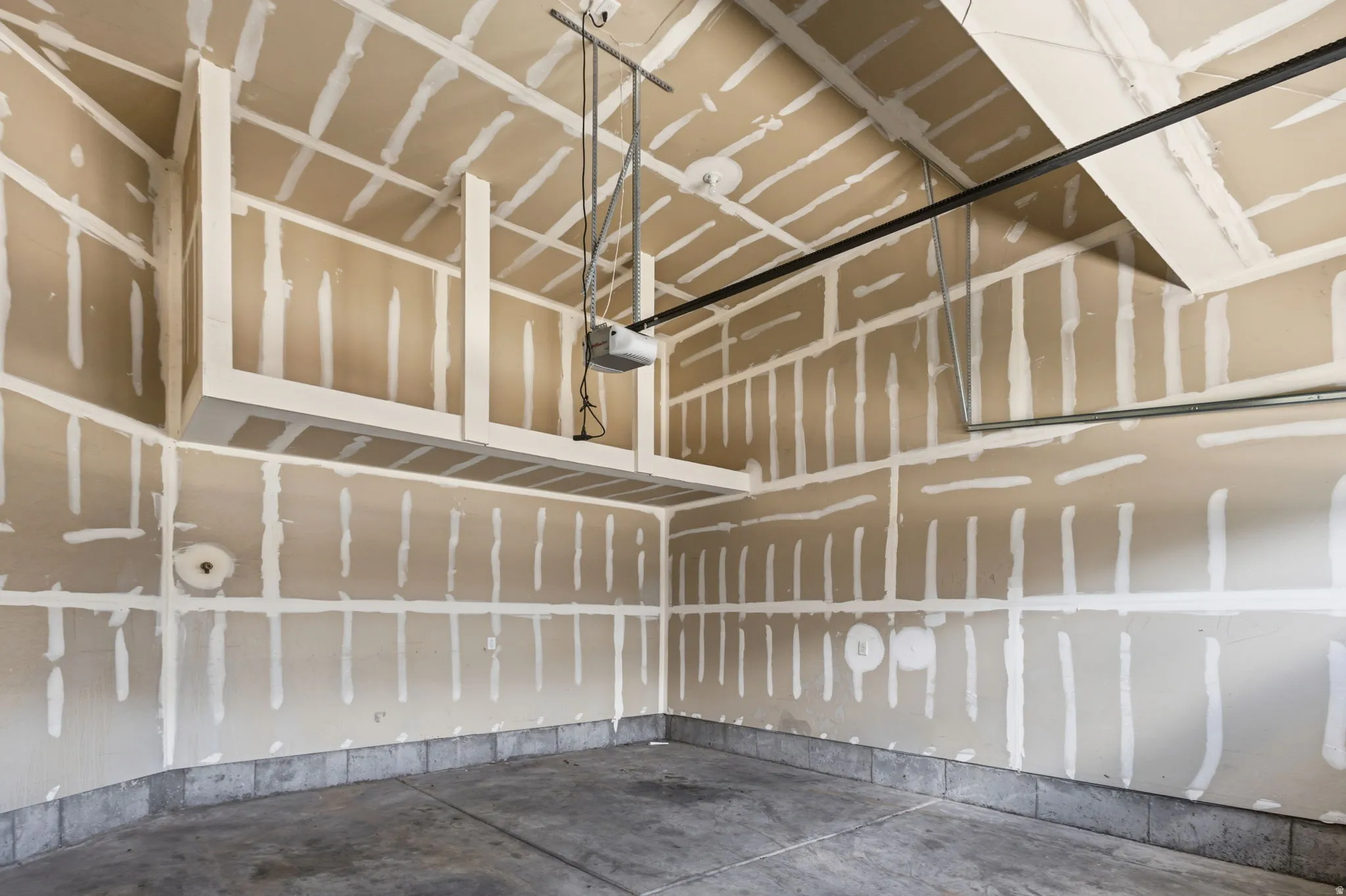 Concrete floor, overhead storage units, and automatic garage door opener