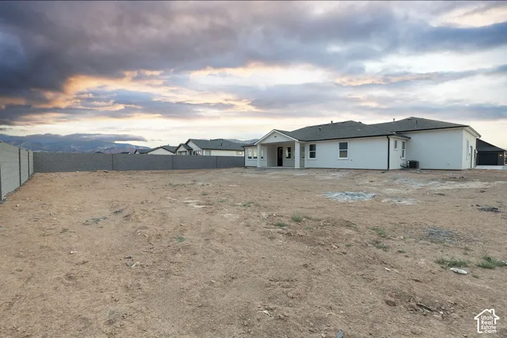 Expansive rear lot featuring a block fence perimeter