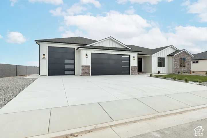 Contemporary exterior with vertical panel siding and brick accents