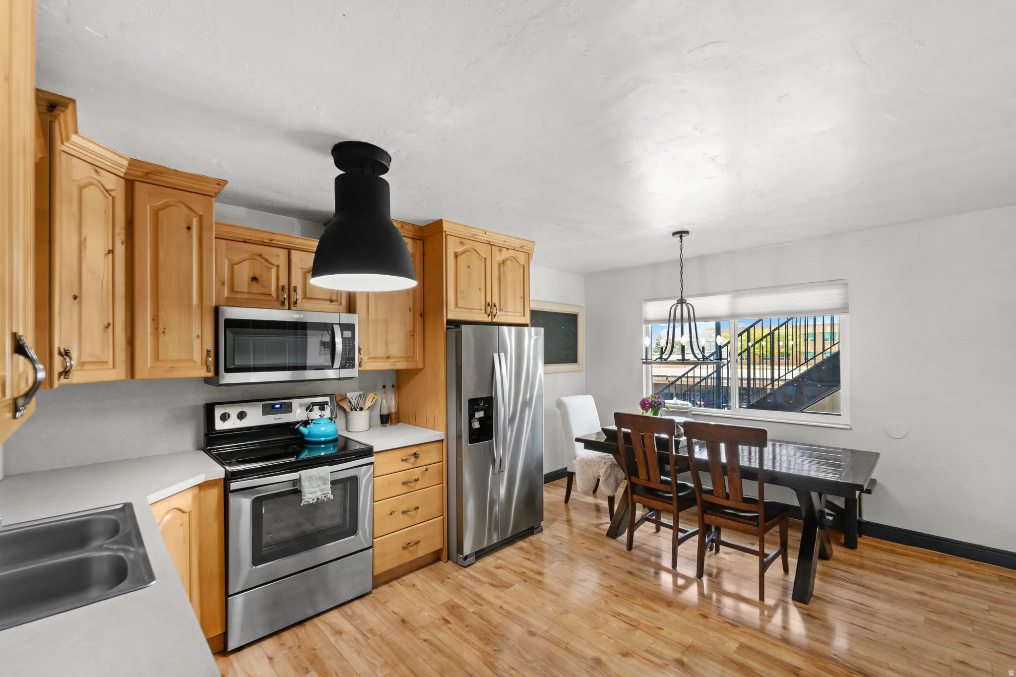 Wood-finish flooring throughout, complemented by light wood cabinetry and light countertops