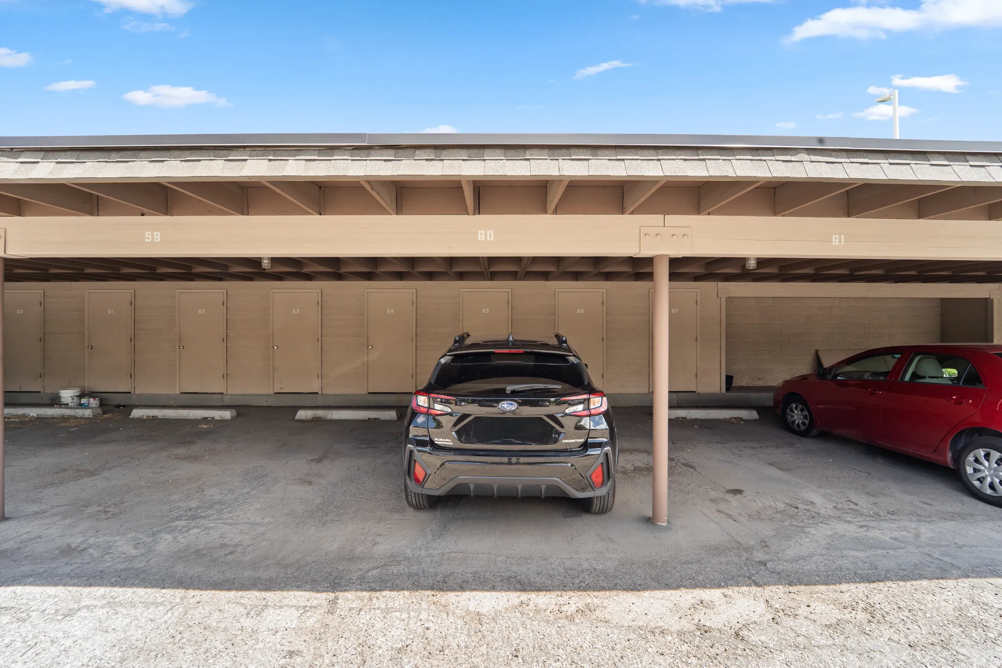 Covered parking with assigned spaces and integrated storage units
