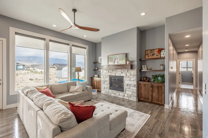 Bright, open living area featuring fireplace with custom built ins