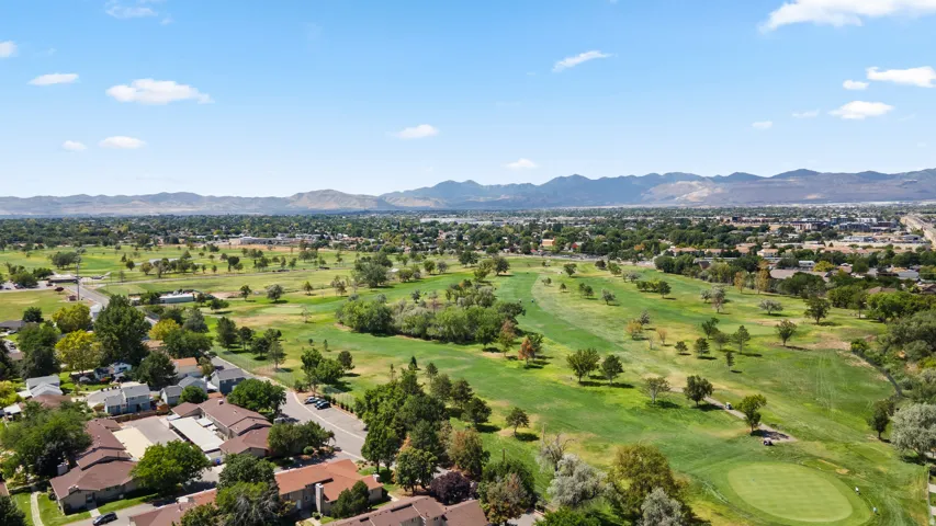 Expansive golf course setting featuring manicured fairways and mature trees
