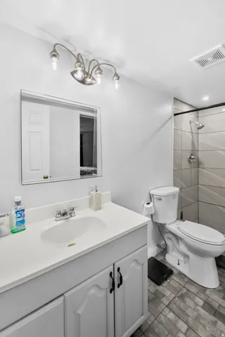 Vanity with white countertop, chrome faucet, and integrated sink