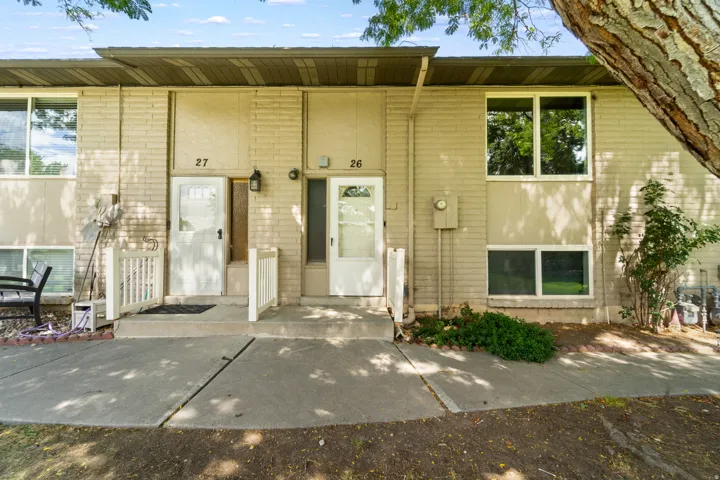 Brick and stucco exterior with multiple windows