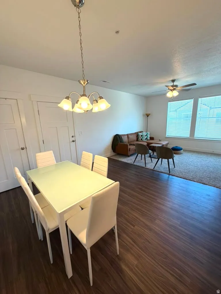 Wood-finish flooring throughout, complemented by a multi-light chandelier