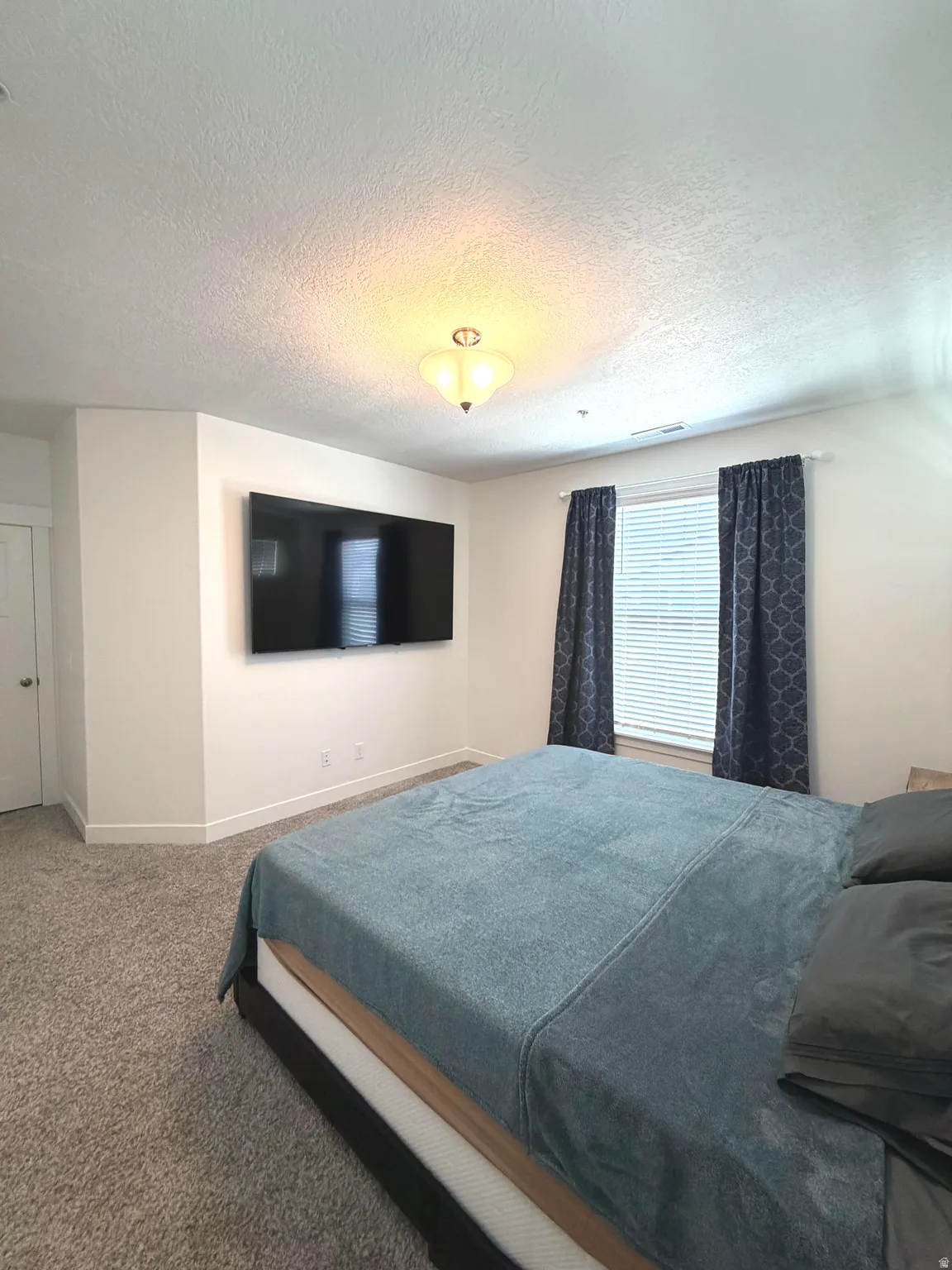 Wall-mounted television with visible wiring