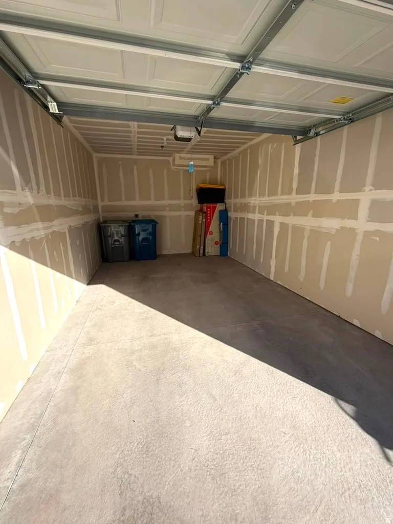 Concrete flooring with a panel-style garage door