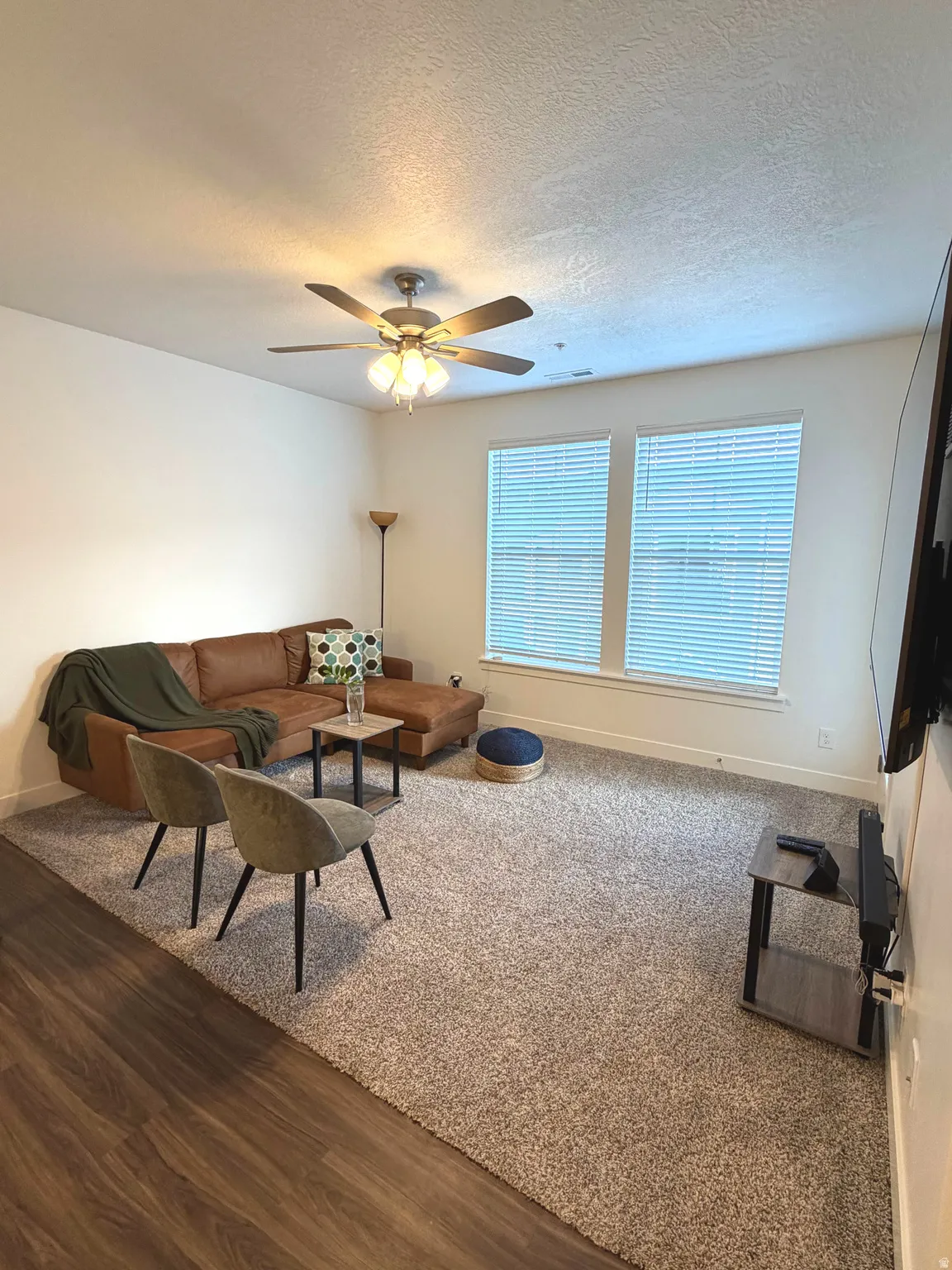 Wood-finish flooring, recessed lighting, ceiling fan, and dual windows with blinds