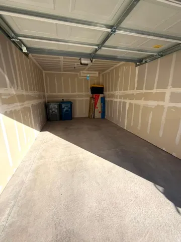 Concrete flooring with a panel-style garage door