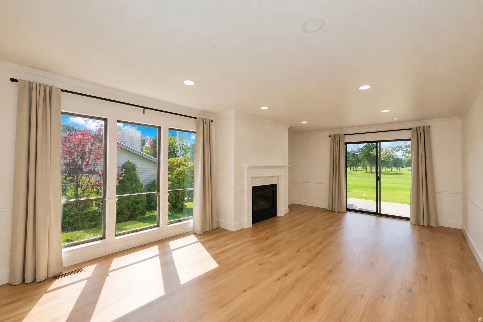 Wood-finish flooring, recessed lighting, and a fireplace with a classic mantel