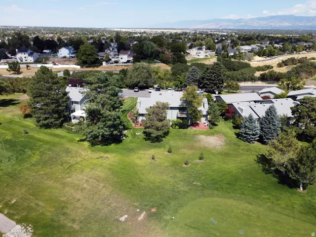 Community setting with established landscaping, paved parking areas, and a distant mountain range
