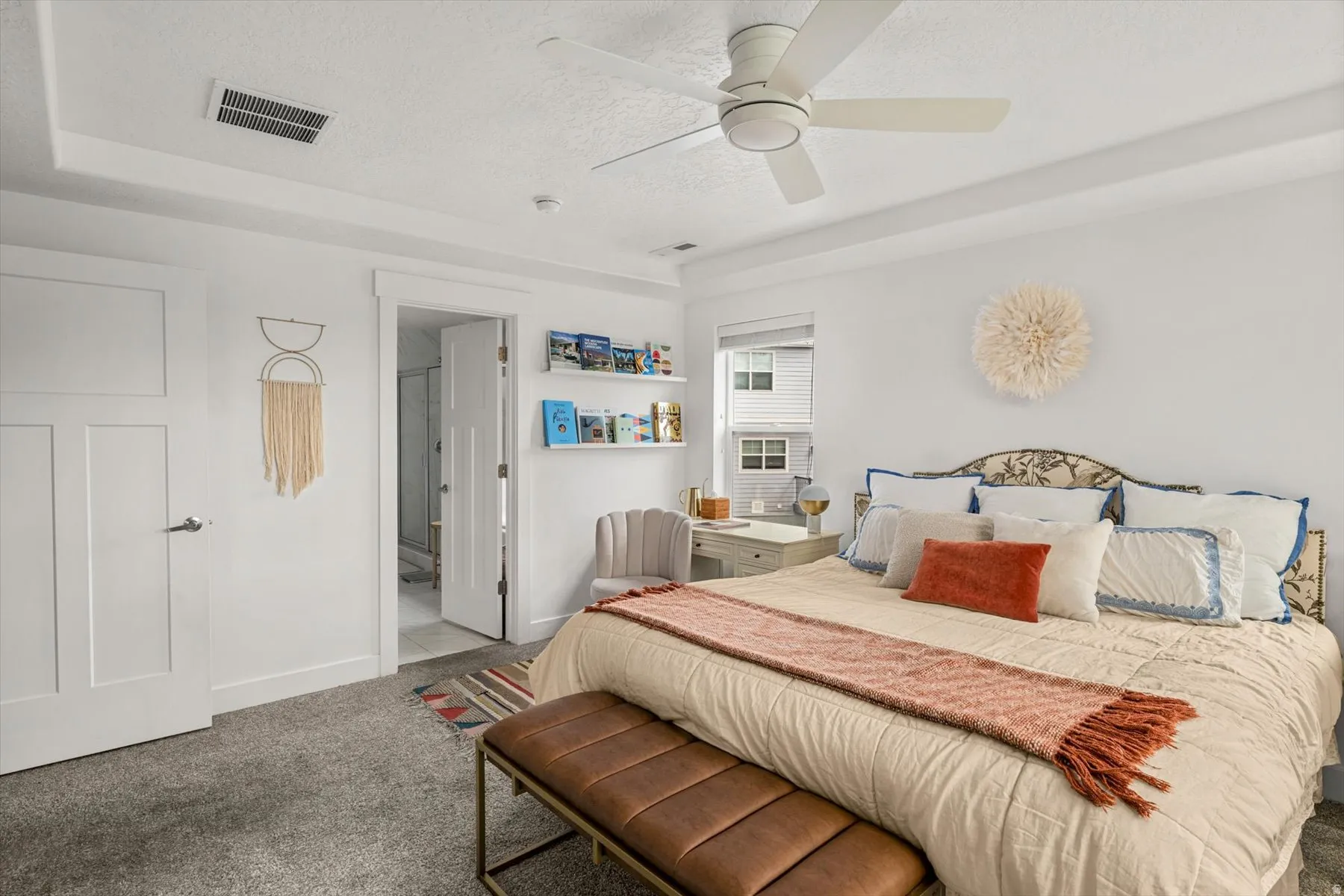 Tray ceiling with recessed lighting and a ceiling fan, plush carpet flooring, and a white paneled door
